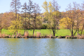 Regensburg, Germany: people are riding the bike on a rural road at sunset along Danube river in Regensburg, Germany, Europe.