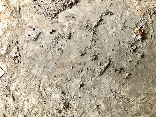 Cement mixture leftover after mixting in a surface.