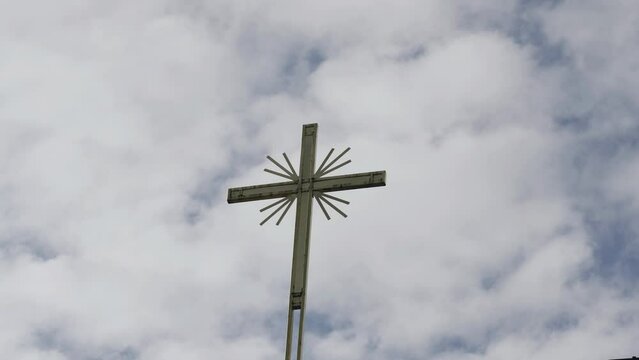 Orthodox cross against the background of moving clouds