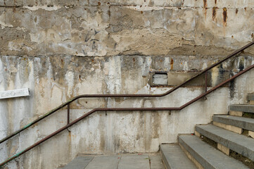 Weathered and abandoned outdoor stairs with rusty railing