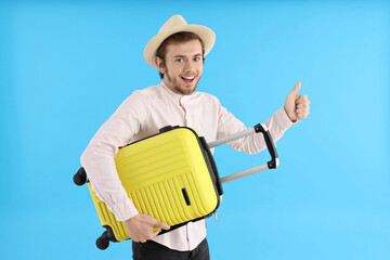 Concept of travel, young man on blue background