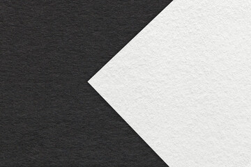 Texture of black and white paper background, half two colors with arrow, macro. Structure of dense...