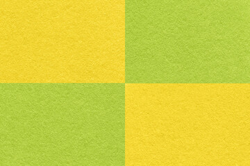 Fototapeta premium Texture of craft green and yellow paper background with cells pattern, macro. Structure of vintage dense kraft cardboard