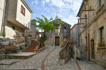 A narrow street between the old houses of Petina, a village in the mountains of Salerno province,...