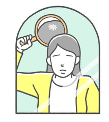 合わせ鏡をして頭頂部の薄毛に悩む若い女性