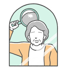 合わせ鏡をして頭頂部の薄毛に悩む中年女性