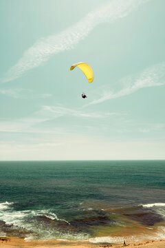 Yellow parachute on the coast with a horizon