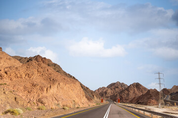 A road next to a mountainous desert landscape. Road 12 on the way to Eilat, Israel, on the Egyptian...