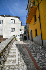Obraz premium A narrow street between the old houses of Petina, a village in the mountains of Salerno province, Italy.