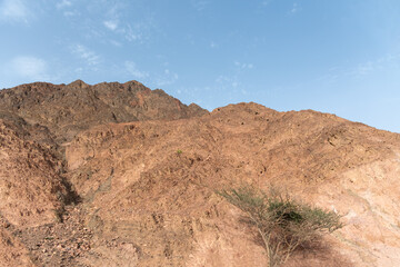 A road next to a mountainous desert landscape. Road 12 on the way to Eilat, Israel, on the Egyptian border. Mountains in different and varied sand colors. High quality photo