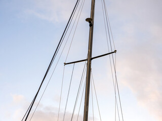 Yacht mast with ropes with sky in background