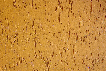 Old texture yellow acrylic plaster. Wall surface decoration materials