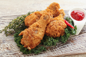 Fried chicken drumsticks with tomato sauce
