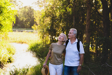 happy senior couple on a nature walk