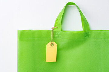 Blank paper tag with shopper paperbag on white background