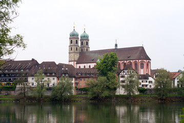 Fototapeta na wymiar City of Bad Säckingen, Baden-Württemberg, with church and Rhine River on a cloudy spring day. Photo taken May 6th, 2022, Stein, Switzerland.