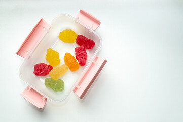 several marmalades in a plastic container