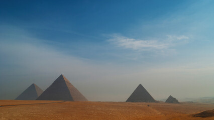 The great Egyptian pyramids. The deserted landscape with pyramids on Giza Plateau.