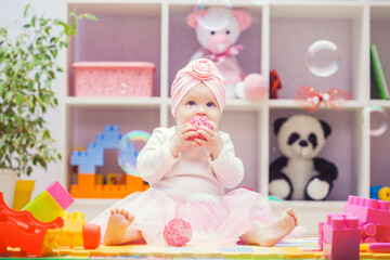 baby playing with colourful building blocks at home or kindergarten