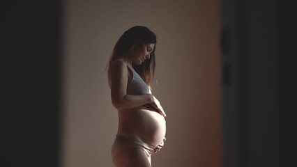 pregnant woman. health pregnancy motherhood indoors procreation concept. close-up belly of a...