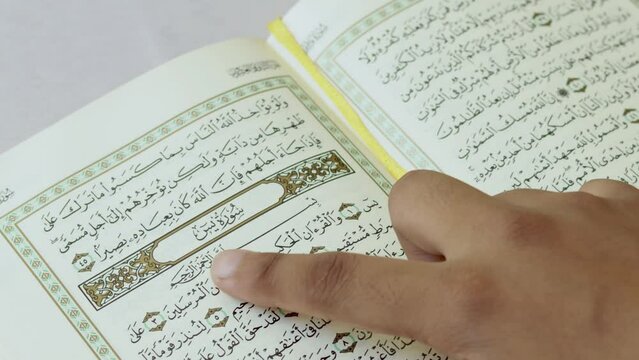 The index finger of a Woman spells one by one the Arabic letters in the Quran at Surah Yaseen 36th chapter of the Qur'an. The surah titled in English means "Ya Sin" and it consists of 83 verses. India