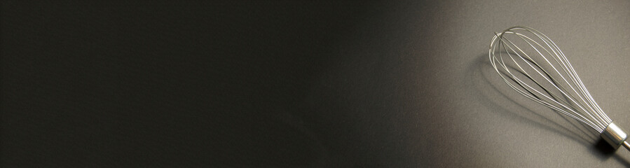 whisk on a gray background. blender part. Banner for insertion into site. Place for text cope space.