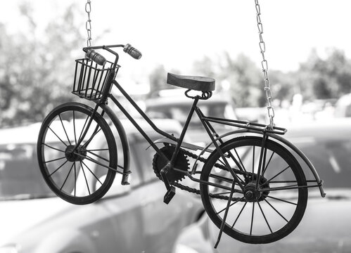  bicycle in  form of  suspension hanging on  chain. Symbol of  healthy lifestyle. Black and white photo