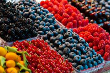 Colorful fruit berries are displayed in a market