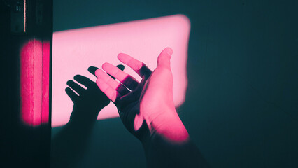 A hand and the shadow in shades of pink