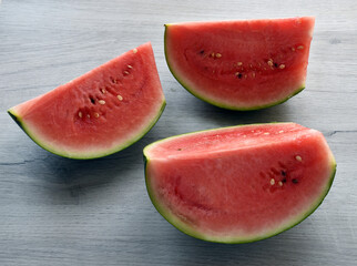 Fresh slices of watermelon isolated on wooden table.