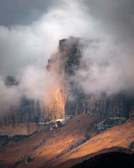 High mountain cliff with low clouds in Caucasus region in Russia