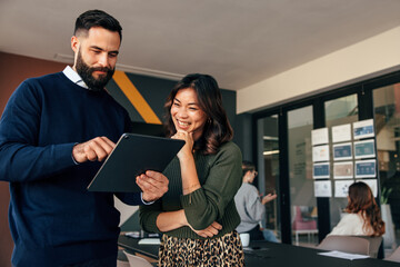 Business colleagues using a digital tablet in a boardroom