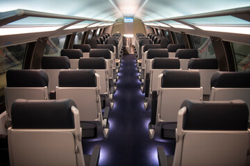 Empty comfortable modern seats inside business class cabin of fast speed European train. Interior...