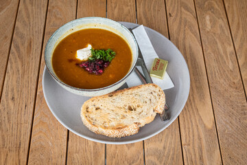 soup and crusty bread on wooden table