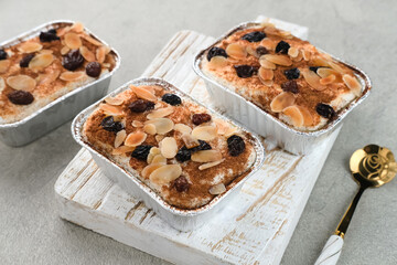 Klappertaart is one of indonesian traditional dessert, from Manado. Coconut custard cake with raisin and almond topping, dusted with cinnamon powder, Dutch influenced dessert. 