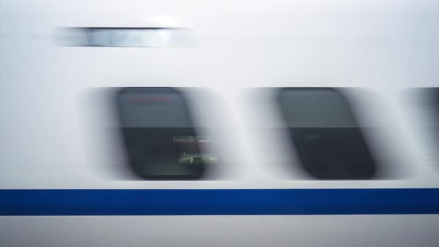 The High-Speed Trains Going By In An Extreme Motion Blur. All logos and trade marks digitally obscured.