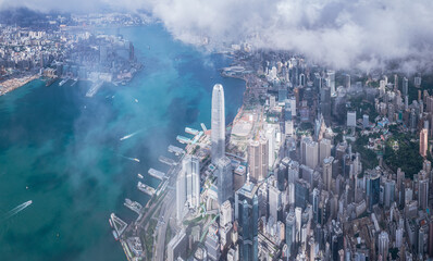 Epic aerial view of the Victoria Harbour in a clear day, with thick cloud and sunlight, Hong Kong