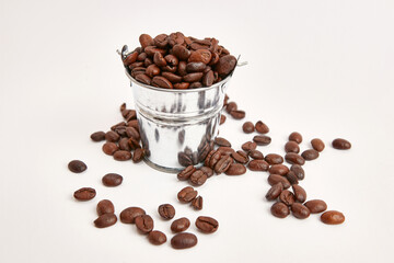 Metal bucket with roasted coffee beans.