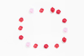 Red and pink rose buds on a white background