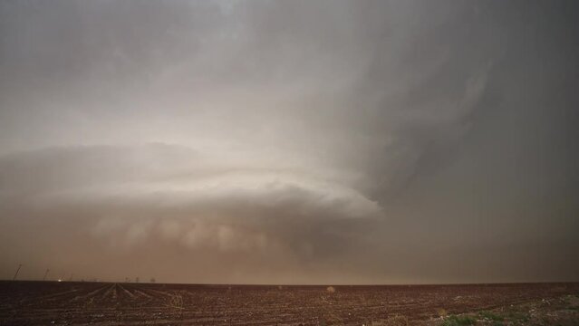 Supercell storm moving through Texas as lightning flashes and dirt blows during tornado warning near Morton.