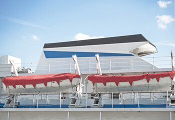 Rigid lifeboats for emergency evacuation hanging on passenger ship