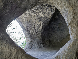 Bas-relief Master of Mountains in cave. Travel attraction in Kislovodsk park