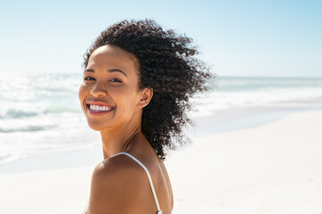 Happy smiling african american woman at beach