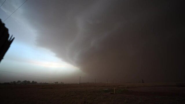 Panning view of supercell thunderstorm moving through Texas kicking up lots of dirt and dust.