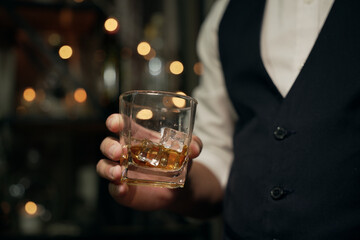 Barman pouring whiskey glass beautiful night