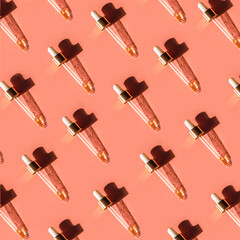 Pipette with gold metallic cap and drops of water, serum, oil, beauty product on pink background. Natural medicine, cosmetic research, bio science. Concept of skincare, analysis. Flat lay, pattern