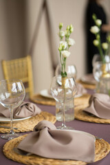wedding table set with transparent glasses, plates