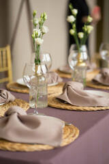 wedding table set with transparent glasses, plates