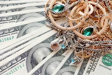 Many expensive golden and silver jewerly rings, earrings and necklaces on big amount of US dollar...