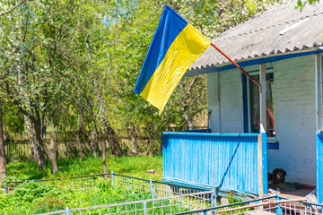 Ukrainian flag on free rural Ukraine house